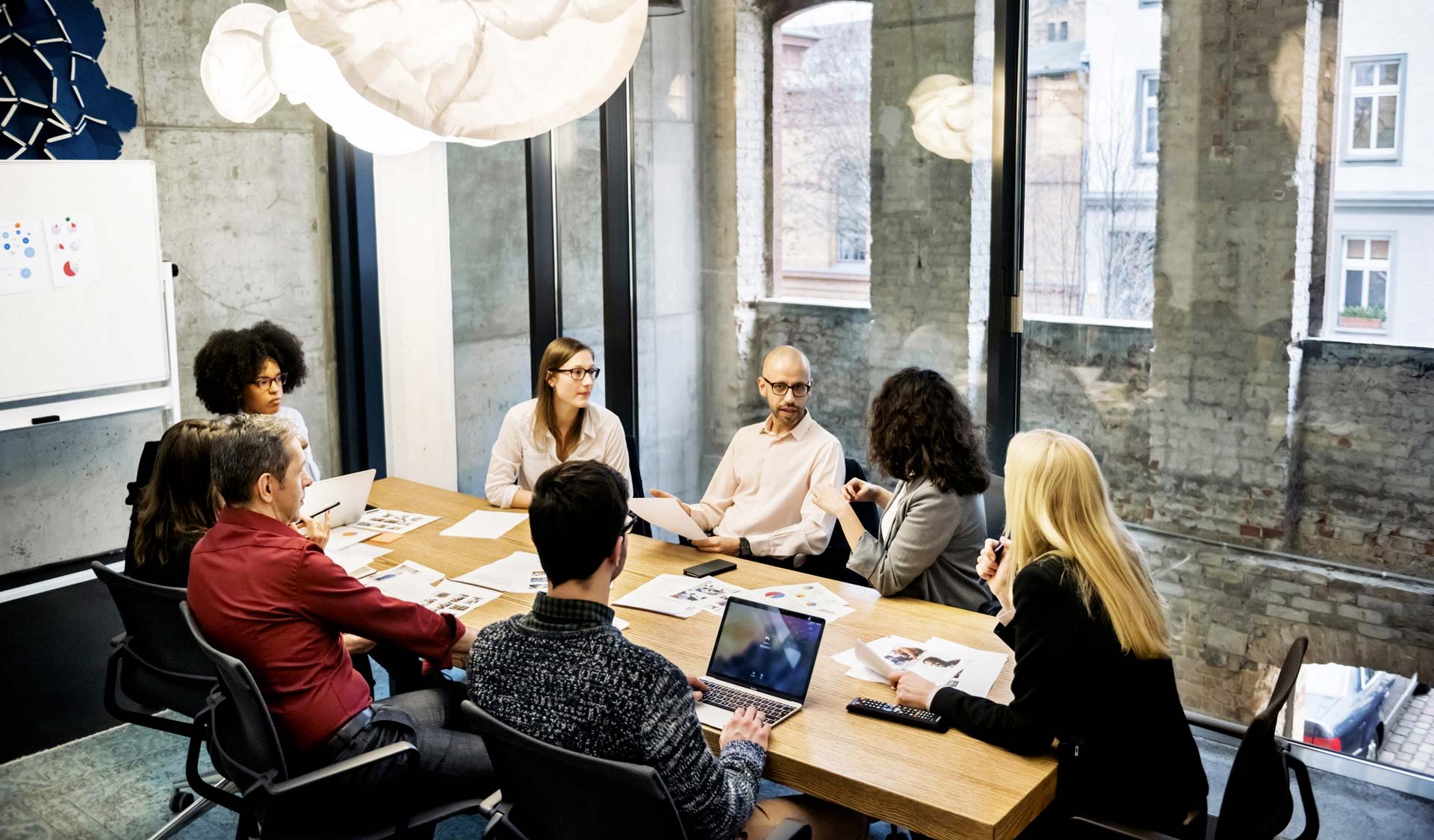 Colleagues discuss in a meeting room